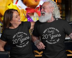 two people wearing t - shirts that say 20 years