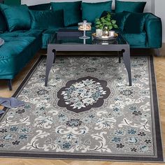 a living room filled with green couches and furniture