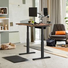 a living room with a chair, desk and bookshelf on the floor in front of a window