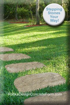 stepping stones in the grass with a sign that says stepping stones are the way on it