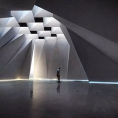 a person standing in front of a white structure with light coming from it's windows