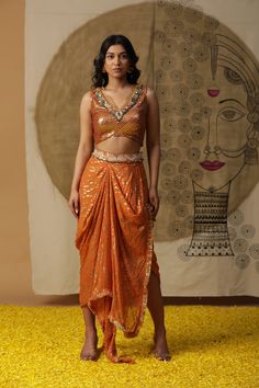 Featuring our apricot dhoti set with hand embroidery on the neckline. Comes with a georgette cape and dori work on the waist belt of dhoti. Fabric : GEORGETTE ORANGE Color FIT FITTED Lining Material crepe 15 DAYS Delivery 3 Components Festive Draped Traditional Sets, Festive Traditional Draped Sets, Navratri Draped Sets With Mirror Work, Traditional Draped Lehenga With Mirror Work, Traditional Draped Sets For Navratri, Navratri Draped Sets With Zari Work, Navratri Draped Traditional Wear With Mirror Work, Navratri Traditional Wear With Mirror Work And Draped Style, Navratri Traditional Wear With Mirror Work And Draped Shape