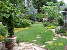 a garden with lots of green grass and trees