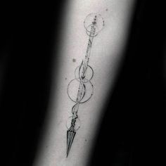 a black and white photo of a person's arm with an arrow tattoo on it