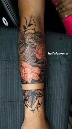 a woman's arm with a snake and flowers tattoo on the left side of her leg