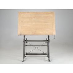 a wooden table with metal legs and a shelf on the top that is holding a sheet of paper