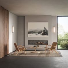 a living room with two chairs and a table in front of a painting on the wall