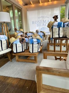 several chairs with hats and bags on them in front of a storefront window that says rosema beach