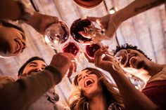 a group of people toasting with wine glasses