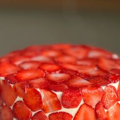 a close up of a cake with strawberries on it