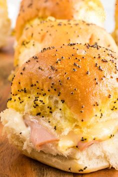 ham and cheese sliders with poppy seed sprinkles on a cutting board