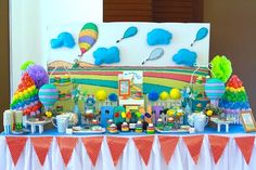 a table topped with lots of candy and balloons