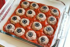 a casserole dish with meatballs and olives in it, ready to go into the oven