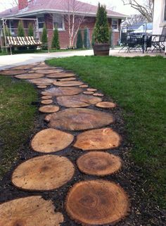 a path made out of logs in the grass