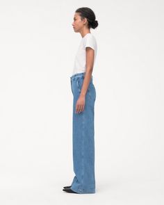 High-waisted, with a straight leg fit, these pants have a slimming effect enhanced by elongating front seams extending from thigh to ankle. A double hook and bar closure with an interior button provide a clean finish in the front, while the back is fit to provide lift and shape.Our denim is made from organic cotton processed in a GOTS-Certified Italian mill. We’ve invested in working with a responsible denim mill that measures their impact and uses data to push the industry forward. They’ve deve Water Consumption, Simple Tees, Denim Trousers, High Waisted Denim, The Foundation, Skirt Top, Plastic Free, Sustainable Fashion, Dresses For Sale