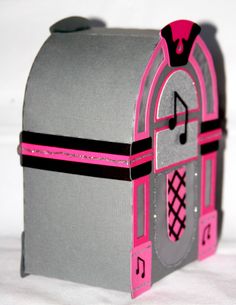 a gray and pink mailbox with music notes on it