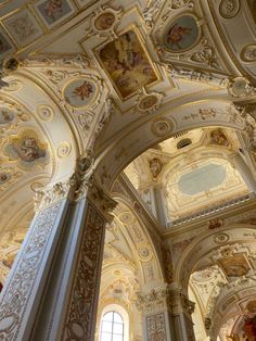 the interior of an ornate building with painted ceilings