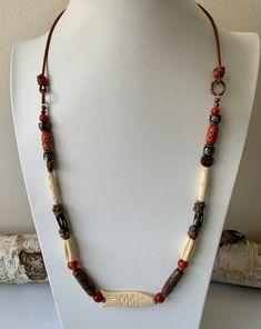 I created this unisex necklace with vintage bone beads, orange agate, coconut shell and copper accents. The focal is a vintage carved bone fish. The length is finished with 1.5 mm leather cord and a lobster claw clasp.  Your necklace will arrive in a jewelry box perfect for gifting or keeping. As always, shipping is free and fast. Thanks for stopping by my shop! Rustic Brown Hand-strung Necklaces, Bohemian Carved Brown Jewelry, Bohemian Brown Carved Jewelry, Adjustable Carved Brown Necklace, Rustic Brown One-of-a-kind Necklace, Bohemian Brown Carved Beaded Necklaces, Bohemian Brown Carved Beaded Necklace, Bohemian Brown Beaded Carved Necklace, Bone Fish