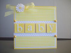 a yellow and white card with the word baby on it