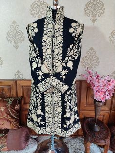 Embroidered Coat, Kashmiri Jacket, Ethnic Coat Walk in Fashion with this Modern Kashmiri jacket with contrasting floral embroidery. This piece will make you look royal and rich with its dark and light colour combination and is ideal for weddings, parties, and other festive occasions. The jacket is crafted in white Aari embroidery over the button line, sleeves and border with special attention to synchronised design pattern. The back panel featuring big daisy inspired flowers and similar pattern Light Colour Combination, Big Daisy, Embroidery Indian, Embroidered Coat, Aari Embroidery, Boho Jacket, Stage Costume, Aari Work, Jacket For Women