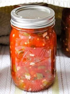 several jars filled with pickled vegetables sitting on a table