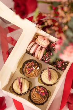 a box filled with cupcakes sitting on top of a table