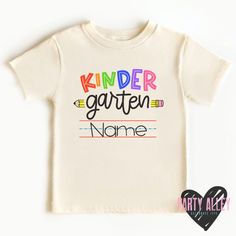 "Kindergarten shirt | Back to school shirt | First day of kindergarten| First day of school | Kinder | Personalized kindergarten | Custom tee See shop announcement for current processing time. A \"rush my order\" listing is available in the add on/upgrade section, please message me beforehand if you will need to rush your order to make sure its possible. Rush order does not include shipping cost.  Please note - Colors on your screen may appear different from the final product." Kindergarten Shirt Ideas, Back To School T-shirt With Name Print For Daycare, Name Print T-shirt For Daycare And Back To School, Name Print T-shirt For Daycare With School Spirit, Playful T-shirt With Name Print For School Year End, School Spirit T-shirt For Birthday And Back To School, Spring School Spirit T-shirt For School Events, Playful Letter Print T-shirt For School Events, Graphic Tee Shirt With Name Print For School