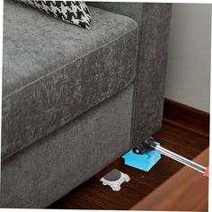 a couch that is sitting on the floor with a remote control in front of it