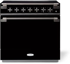 a black stove with four burners and two oven doors on each side, in front of a white background