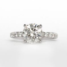 a diamond engagement ring on a white background