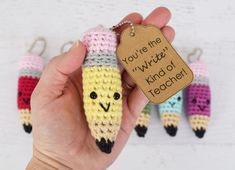 a hand holding a crocheted keychain shaped like a corn cob with the words you're me written on it