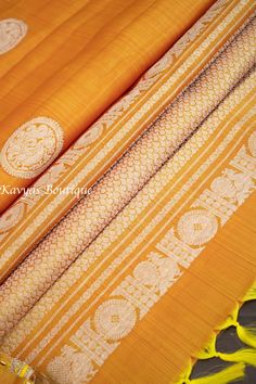 An exquisite Handloom Kanchivaram Pure Silk Saree in a Yellow Mustard color. Silk Mark Certified. The saree features silver zari peacock motifs throughout the body with a beautiful silver border with yellow selvedge on both sides. The pallu of the saree is same color as the body with heavy silver zari work.  Comes with yellow mustard aari work blouse stitched to size 38. Expandable to size 40/42. Fall and pico done and saree is ready to wear. There is tassels on pallu side of the saree. Blouse stitched - Yes Blouse Opening - Front Sleeves Length - Elbow Padded - No Blouse size - 38, expandable upto 40/42 NO RETURNS on sarees with stitched blouses.  They are tailored to standard size and not custom made - so may not be a perfect fit for you. Please reach out if you have questions with measu Ceremonial Yellow Saree With Zari Work, Silk Thread Traditional Wear With Motifs For Puja, Ceremonial Yellow Dupatta With Zari Weaving, Ceremonial Yellow Handloom Saree, Yellow Handloom Traditional Wear For Ceremonial Use, Ceremonial Silk Thread Traditional Wear With Cutdana, Ceremonial Yellow Dupatta With Traditional Patterns, Yellow Ceremonial Dupatta With Traditional Patterns, Ceremonial Silk Traditional Wear With Cutdana