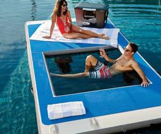 a man and woman sitting on a floating bed in the water