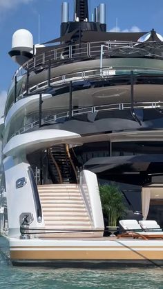 a large white boat in the water with stairs leading up to it's upper deck