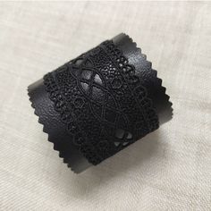 "A gorgeous unique black leather cuff bracelet for women made of genuine Italian leather and black lace is a great present for mom. This wide black cuff is very lightweight and has a comfortable snap button clasp. Measurements: Bracelet width: 2.5\" Available sizes (distance between the middle of the buttons) : To determine your size: tightly measure your wrist, and add 0.8 inches (2 cm's) for a comfortable fit. Bracelet size 7.3 inches Custom sizes can be made, please feel encouraged to contact Black Bohemian Leather Bracelet, Trendy Black Cuff Leather Bracelet, Leather Cuff Bracelet For Party, Gift Leather Cuff Bracelet With Black Band, Black Cuff Leather Bracelet For Party, Black Cuff Leather Bracelet Gift, Adjustable Leather Cuff Bracelet For Party, Black Band Leather Cuff Bracelet Gift, Black Leather Cuff Bracelet For Party