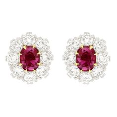 Dating to the 1950s this eye catching pair of cluster earrings feature a 1.00 carat natural ruby in each. The vibrant rubies are oval cut stones and have had some heat treatment. They are surrounded by eight 0.25 carat diamonds per ear. The round brilliant diamonds range in colour from G to H and in clarity from VS to SI and have been set into platinum. These vintage earrings feature 18 carat yellow gold posts with butterfly backs Gemstone: Ruby Stone Shape: Oval Cut Carat Weight: 2x 1.00 Age: 1 Diamond Cluster Earrings, Ruby Stone, Ruby Diamond, Cluster Earrings, Natural Ruby, Diamond Cluster, The 1950s, Jewelry Earrings Studs, Oval Cut