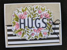 a close up of a card with flowers and the word hugs written on it's side