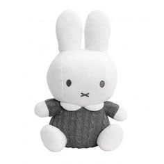 a white stuffed rabbit sitting in front of a white background with black eyes and ears