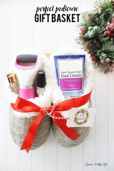 a pair of shoes that are wrapped in fabric and tied with red ribbon, sitting next to a christmas wreath