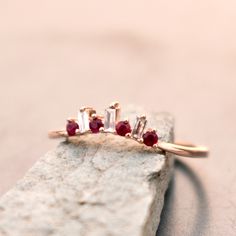 "Alternating diamond baguettes and round natural Rubies in a slight curve, this is a perfect crown stack for your classic solitaire. Set meticulously in a 3 prong setting, the subtle color adds the right amount of pretty to your engagement ring. Crafted in 14K Solid Gold, this ring looks stunning worn by itself or stacked! * Gemstone 1 : Natural Diamonds * Diamond Shape : Baguette * Diamond Wt. : 0.04 Cts (Baguette) * Color-Clarity Grade : G-H-I, Vs-Si * Gemstone 2 : Natural Ruby * Ruby Shape : Promise Band, Diamond Ear Cuff, Diamond Crown, Etsy Wedding Rings, Pear Diamond, Bridal Bands, July Birthstone, Natural Ruby, Baguette Diamond