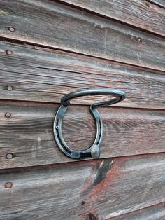 a horseshoe hanging on the side of a wooden building