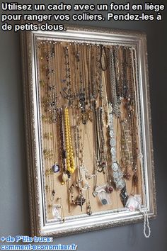 there is a silver frame with many necklaces hanging on it