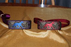 two dog collars are sitting on a table