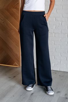 Get ready to slay in style with our Resort Travel Wide Leg Crop Pant! These pants feature a chic navy color and a trendy wide leg design, perfect for any occasion. The banded and elastic waistline provide both comfort and style, while the functional side pockets add convenience. Made from scuba modal fabric, these pants are a must-have for your wardrobe. Scuba Modal Banded Waistline Cased Elastic Back Waistline Functional Side Pockets Wide Leg 95% Polyester, 5% Spandex True to Size S: Waist 27" Navy Gifts, Travel Pants, Modal Fabric, Wide Leg Cropped Pants, Half Zip Pullover, Denim Leggings, Leg Design, Romper Dress, Navy Color