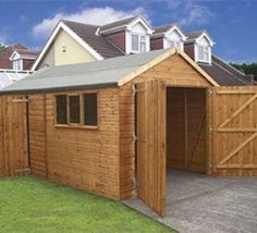 a large wooden shed sitting in front of some houses