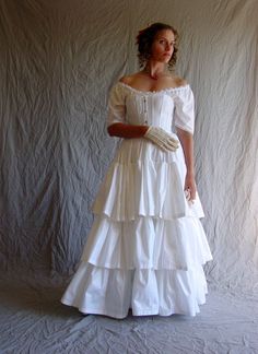 "The bigger the skirt, the closer to perfection! Our Three Ruffled Petticoat creates the wide, round volume often seen during the 19th century. Our Ruffled Petticoat is a full petticoat gathered into the waistband. It has three 12\" ruffles. This petticoat can be worn in a variety of ways: as shown over our boned Hoop skirt for a mid-19th century silhouette, with a bustle pad, or on its own. (See last photo of the petticoat without the hoop.) Hoop sold separately: http://www.etsy.com/listing/770 Historical Victorian Dress With Ruffles, Marie Antoinette Style Victorian Dress With Ruffles, Regency Style Victorian Wedding Dress, Victorian Wedding Dress With Underbust Style, Regency Victorian Dress For Debutante Ball, Fitted Victorian Dress In Crinoline, Victorian Ball Gown Dress For Theater, Historically Designed Fitted Dress, Regency Style Dresses With Historical Design