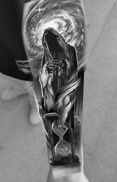 black and white photo of a person's arm with an hourglass tattoo on it