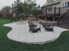 an outdoor patio with chairs and stairs