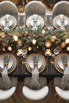 the table is set with silver and gold plates, napkins, and place settings