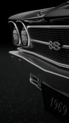 the front end of a classic car in black and white